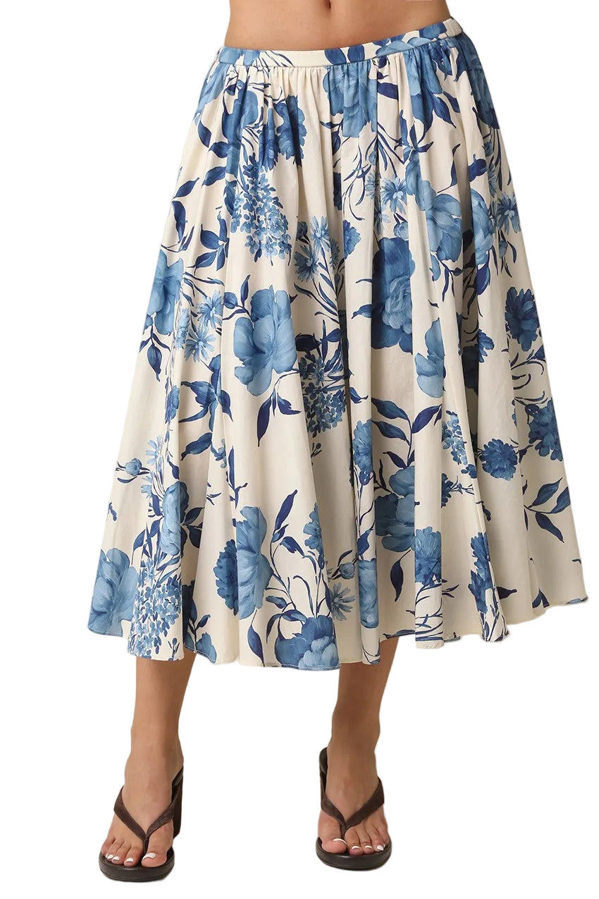 Twirl into spring with the Edith Midi Floral Skirt, a breezy blend of cream and blue florals that dances between casual and polished. This midi length hits just right for effortless elegance, whether you're heading to brunch or a garden party. The soft floral print brings movement and personality to your everyday rotation, while the flattering silhouette works with everything from sneakers to sandals. Perfect for those days when you want to feel put-together without trying too hard.
