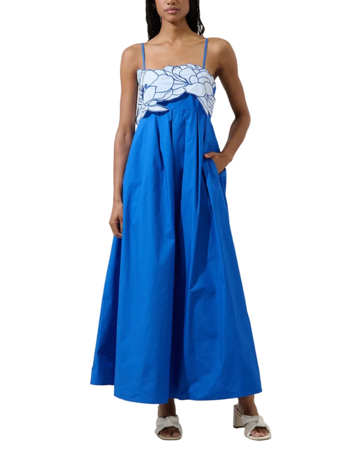 Modern romance in full bloom. This stunning maxi dress features a soft neutral skirt paired with a statement floral bodice that adds texture. The delicate straps and structured top create a flattering, feminine shape, while the flowing skirt brings effortless elegance with every step. Perfect for special occasions, sunset dinners, or any moment that calls for understated drama.
- Embroidered