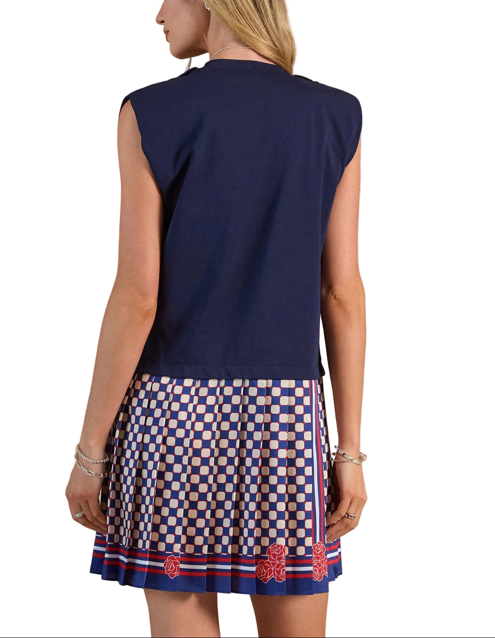Effortless elegance meets playful style in this charming mini dress. The knit dropped waist top features a relaxed, comfortable fit that skims the body, while the woven pleated skirt adds movement and dimension with its crisp, structured folds. The navy multi colorway brings versatility to your wardrobe—dress it up with heels for evening or keep it casual with sneakers for daytime wear. Perfect for transitional seasons, this piece combines two distinct textures for visual interest and all-day comfort.