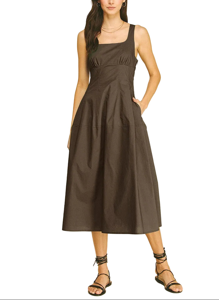 The Marisa Midi Dress offers effortless elegance for any occasion. This sleeveless design features a flattering midi length that skims the body gracefully, making it perfect for warm weather styling. The clean, minimalist silhouette pairs easily with sandals for casual outings or heels for evening events. Versatile and comfortable, it&