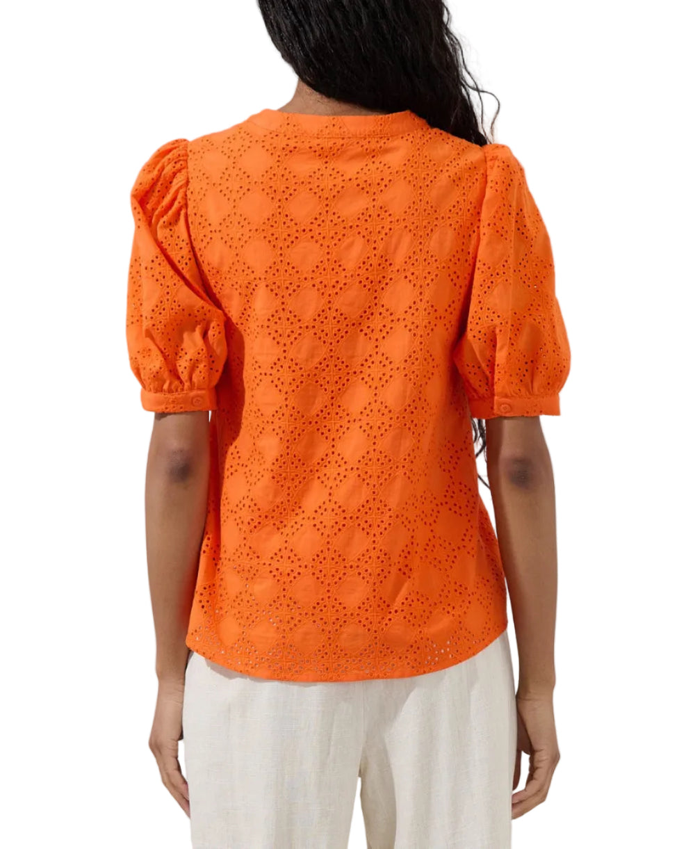 Pretty little details, major style moment! An inspired eyelet embroidery throughout, shapes this blouse that has puff short sleeves and a bodice with a functional button placket at the front. Easy to pair with white pants!