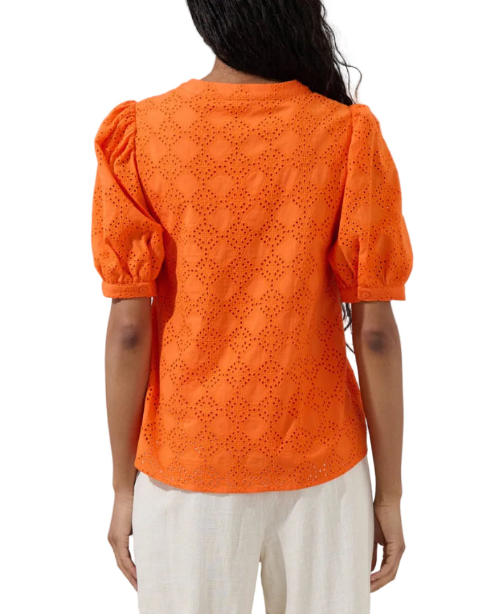 Pretty little details, major style moment! An inspired eyelet embroidery throughout, shapes this blouse that has puff short sleeves and a bodice with a functional button placket at the front. Easy to pair with white pants!