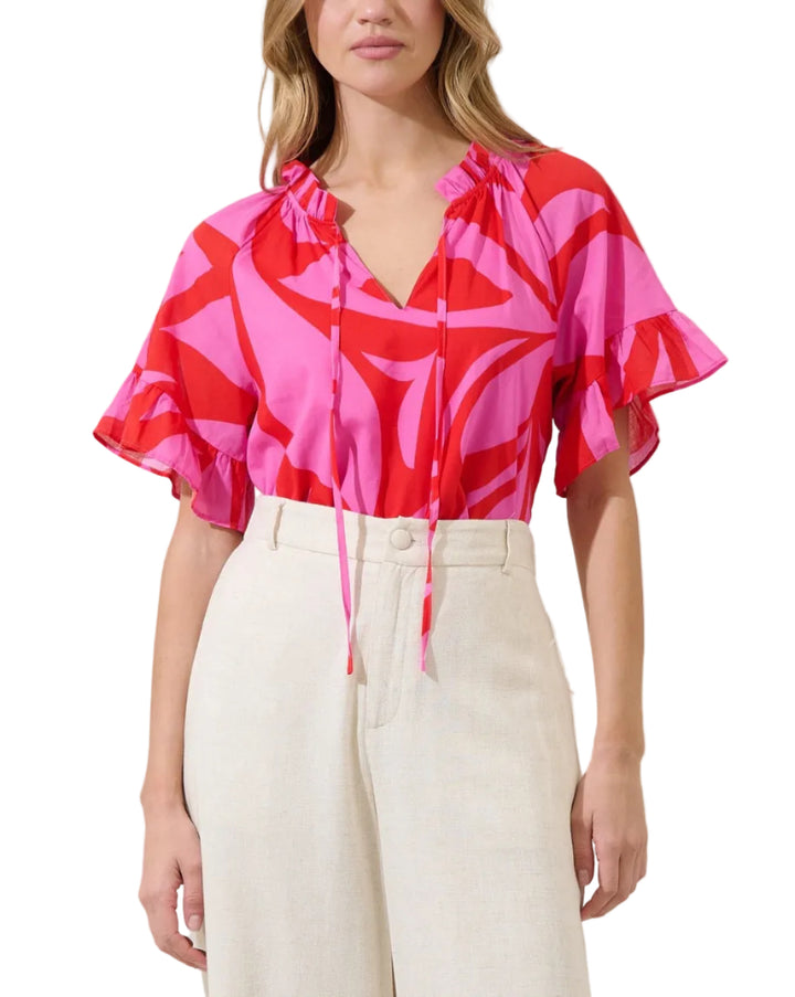 Made for sunshine and sweet moments. This pretty top features short wide sleeves and a split neckline with a tassel tie in the front. Pair it with denim shorts and espadrilles for the perfect look.