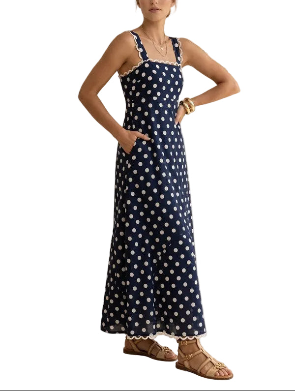 Elegant navy maxi dress featuring classic white polka dots and a flattering square neckline. The timeless polka dot pattern pairs beautifully with the structured square neckline for a sophisticated, vintage-inspired look. Perfect for special occasions, garden parties, or elevated everyday wear. The flowing maxi silhouette offers comfort and grace, while the square neckline adds a modern touch to this timeless design. A versatile wardrobe essential that transitions seamlessly from day to evening.
