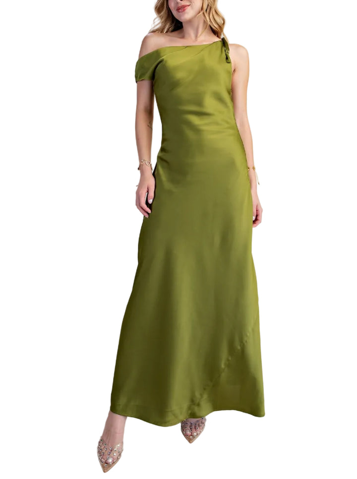 Woman wearing a green off-shoulder dress against a plain background