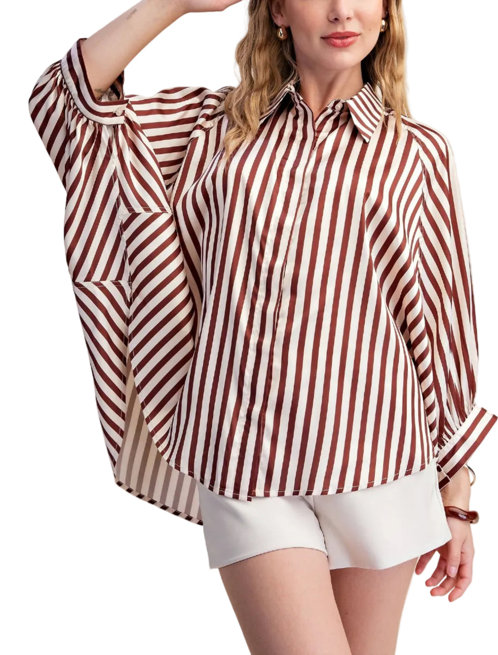 Elevate your wardrobe with this striking white striped shirt. Designed with a relaxed, oversized silhouette and voluminous long sleeves that gather at the cuff, this top offers both comfort and sophisticated style. The classic button-up front and crisp collar add a touch of timeless elegance, making it a versatile piece for any occasion. Crafted from a smooth, flowing fabric, this shirt drapes beautifully, creating a flattering and fashionable look. 