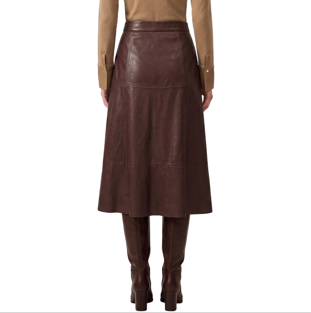 Elevate your wardrobe with the Greta Burgundy Faux Leather Midi Skirt, a sophisticated piece that seamlessly transitions from day to evening. The rich burgundy hue and buttery-soft faux leather construction create a luxurious look without the maintenance of genuine leather. A flattering midi length provides elegant coverage while the sleek silhouette cinches at the waist for a refined shape. Pair with a crisp white blouse for timeless polish or a fitted sweater for contemporary edge.