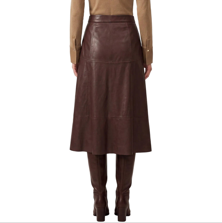 Elevate your wardrobe with the Greta Burgundy Faux Leather Midi Skirt, a sophisticated piece that seamlessly transitions from day to evening. The rich burgundy hue and buttery-soft faux leather construction create a luxurious look without the maintenance of genuine leather. A flattering midi length provides elegant coverage while the sleek silhouette cinches at the waist for a refined shape. Pair with a crisp white blouse for timeless polish or a fitted sweater for contemporary edge.
