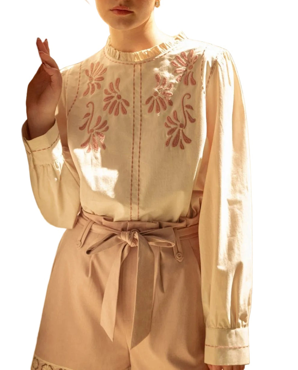 Elevate your everyday wardrobe with the Stella Embroidered Ruffled Mock Neck Top. This charming piece features delicate embroidered detailing paired with feminine ruffled accents at the mock neckline, creating an effortlessly polished look. The soft fabric drapes beautifully while the structured mock neck adds a touch of sophistication. Perfect for layering or wearing on its own, this versatile top transitions seamlessly from casual days to evening occasions. 