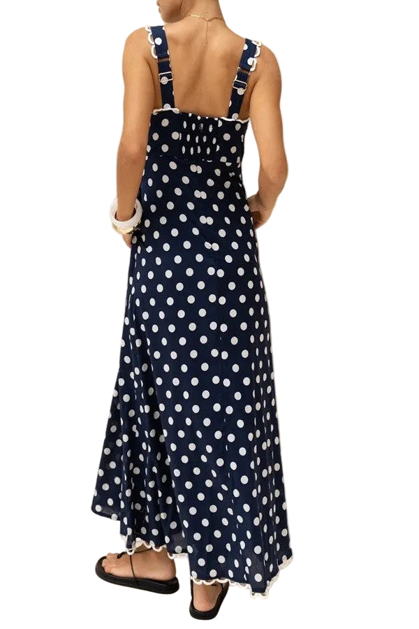 Elegant navy maxi dress featuring classic white polka dots and a flattering square neckline. The timeless polka dot pattern pairs beautifully with the structured square neckline for a sophisticated, vintage-inspired look. Perfect for special occasions, garden parties, or elevated everyday wear. The flowing maxi silhouette offers comfort and grace, while the square neckline adds a modern touch to this timeless design. A versatile wardrobe essential that transitions seamlessly from day to evening.