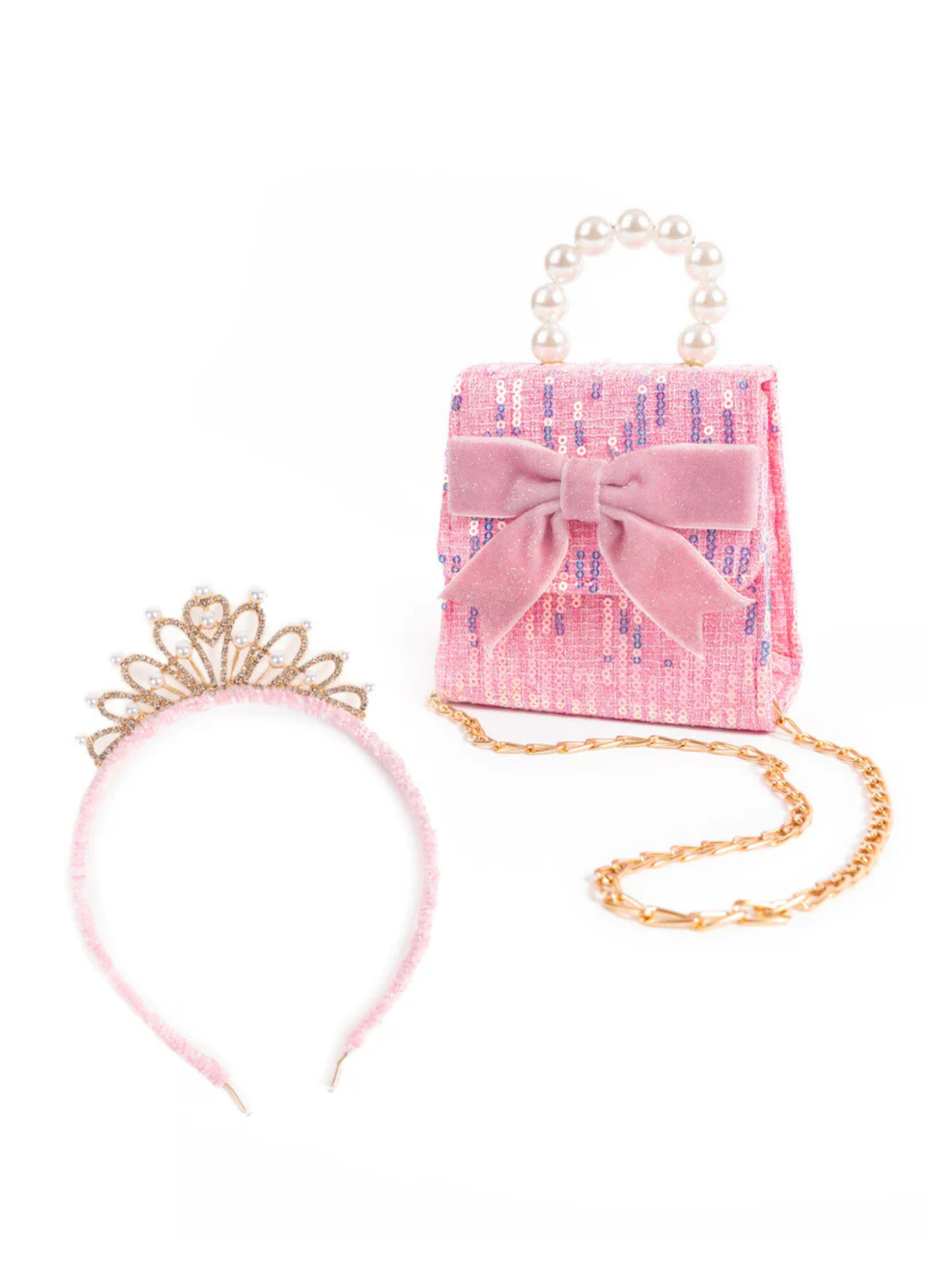 Elegant and eye-catching, The Mademoiselle Mini Purse with Headband, Blue or Pink is a beautifully coordinated set designed to shine. The purse features layered sequins and a statement bow, complemented by a refined pearl handle.&amp;nbsp;The matching headband is finished with a gold crown, creating a regal look.