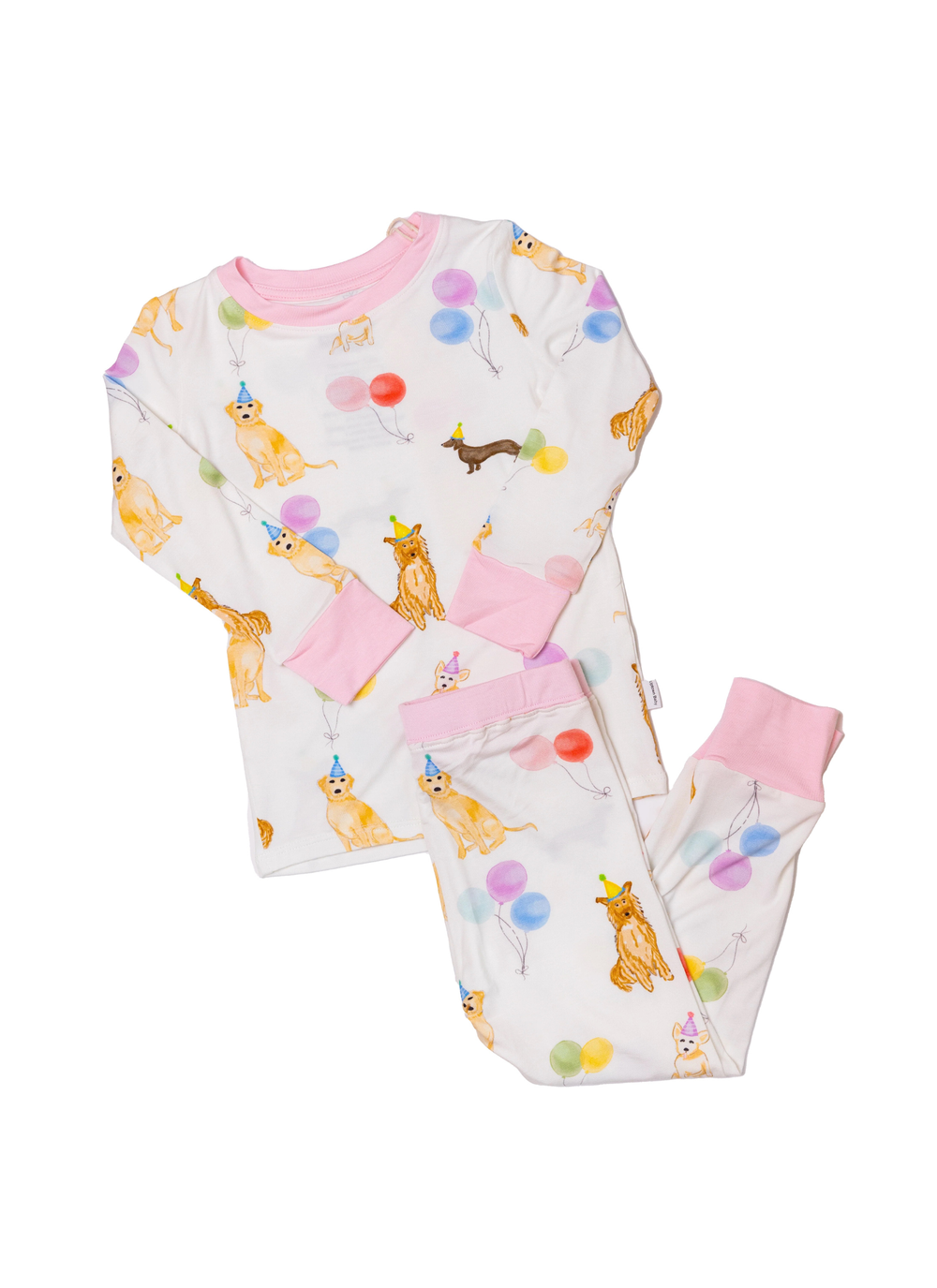 A children's long-sleeve pajama set laid flat on a white background, featuring a white base printed with orange tabby cats, colorful balloons, and small cartoon characters, with pink trim at the collar, cuffs, and waist.