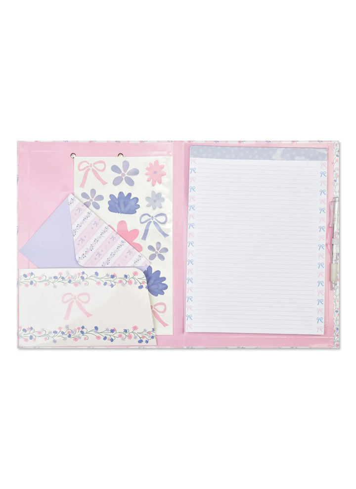 Pink stationery set with decorative elements on a white background