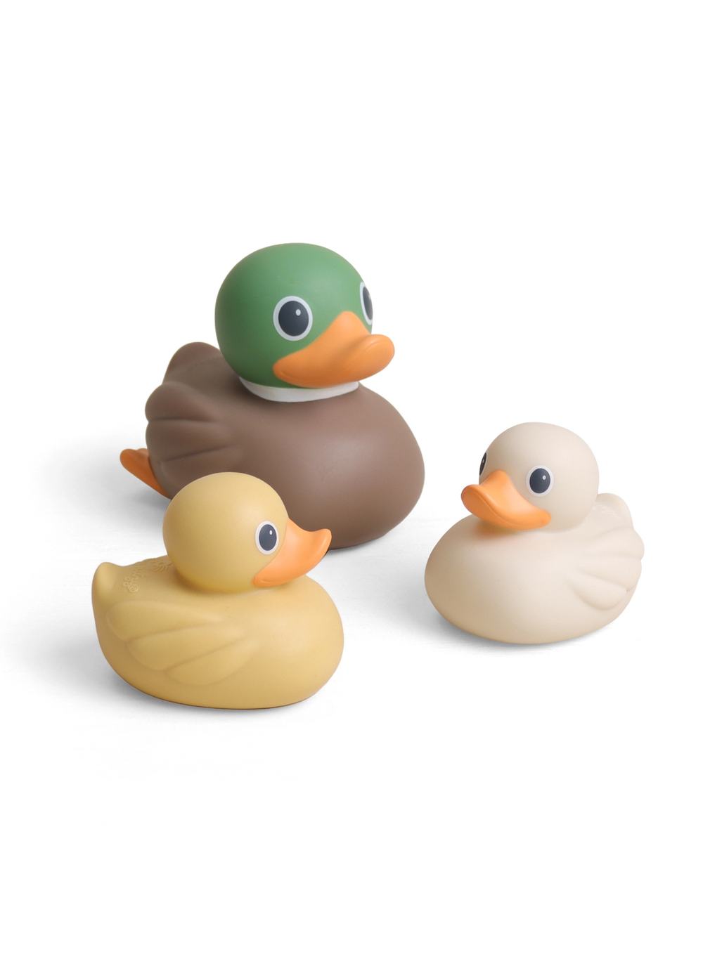 Three rubber duck toy figures on a clean white background: a green-headed duck with a brown body and orange beak, a pale yellow duck, and a cream-colored duck.