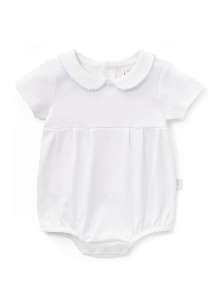 A timeless addition to baby boy’s wardrobe, this classic bubble is crafted from soft organic cotton knit fabric for a light, breathable feel. Designed with a traditional Peter Pan collar accented by delicate picot trim, it features a refined pleated front for a polished, heirloom-inspired look. Comfortable enough for everyday wear yet elevated enough for special occasions, this versatile style is perfect for family gatherings, photos, celebrations, and milestone moments. The gentle silhouette allows for eas