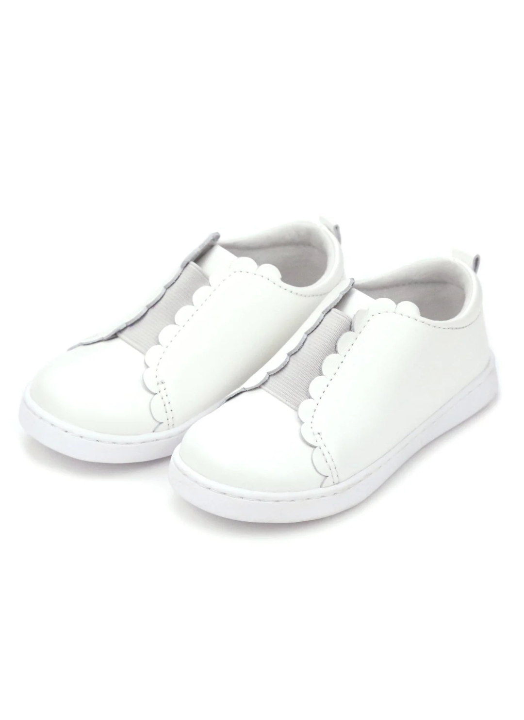 Scalloped and sweet, sister to the Caroline, the Phoebe is the first slip on sneaker in our collection. We love the matching elastic for a semi-sporty look; Phoebe comes with a leather sock bed with memory foam for greater breathability, durability, and comfort as leather conforms to the shape of the foot.