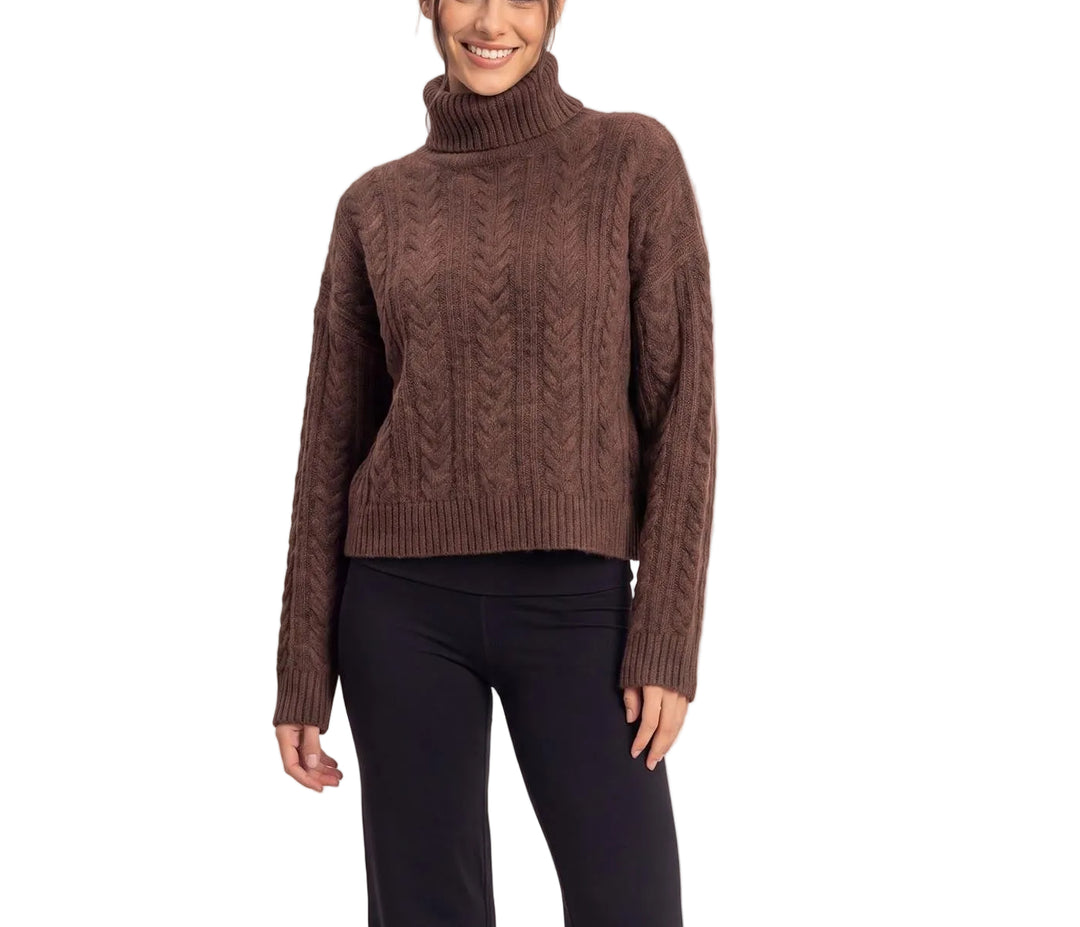 Effortless sophistication meets timeless comfort in the Marisa Cable Knit Turtleneck Sweater. This classic piece features a chunky cable knit texture that adds visual interest and warmth, perfect for layering or wearing solo. The fitted turtleneck and ribbed cuffs provide a polished silhouette, while the soft knit fabric drapes beautifully against the skin. Ideal for cooler seasons, this versatile sweater pairs seamlessly with jeans, trousers, or skirts for an elevated everyday look.