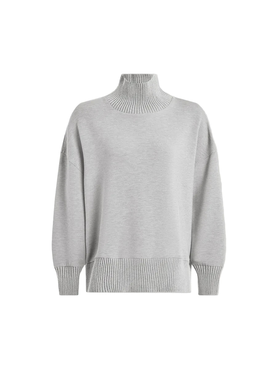 A light gray knit turtleneck sweater with ribbed collar, cuffs, and hem, displayed on a neutral off-white background.