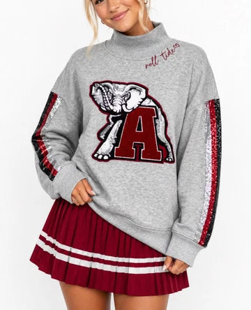 This is an Officially Licensed Collegiate Product
Soft gray mock neck sweatshirt featuring a bold Alabama elephant and “A” appliqué for a classic collegiate look
Eye catching sequin stripe detailing down each sleeve adds just the right amount of sparkle and contrast
Crafted from soft cotton Terry sweatshirt material 
Material: 80% Cotton, 20% Polyester
STYLE NOTE: This sweatshirt is made to fit oversized. You should purchase your normal size if you want the oversized look and fit. If you want a more fitted 