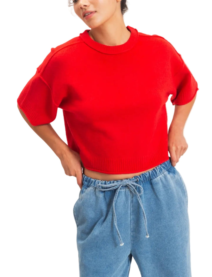 Embrace the relaxed silhouette of this ribbed crew neck pullover top, featuring elbow-length sleeves and a straight hem. With rolled raw-edge sleeves and hem, the versatile cut is ideal for layering over a collared shirt for a chic office ensemble or pairing with high-waisted jeans for a laid-back weekend vibe.