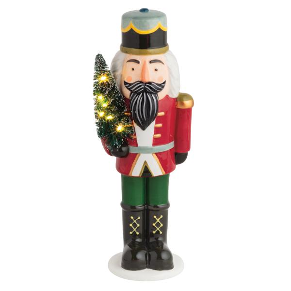 This exquisite Large Light-Up Nutcracker Sitter is a charming addition to your holiday décor. Crafted from high-quality hand-painted ceramic, this nutcracker showcases intricate detailing and vibrant colors that capture the festive spirit. Standing proudly, it holds a delightful light-up bottle brush tree, adding a warm and inviting glow to any room. The included batteries ensure it's ready to illuminate your space right out of the box. Measuring 11 inches in height and 3 1/4 inches in diameter, this piece 