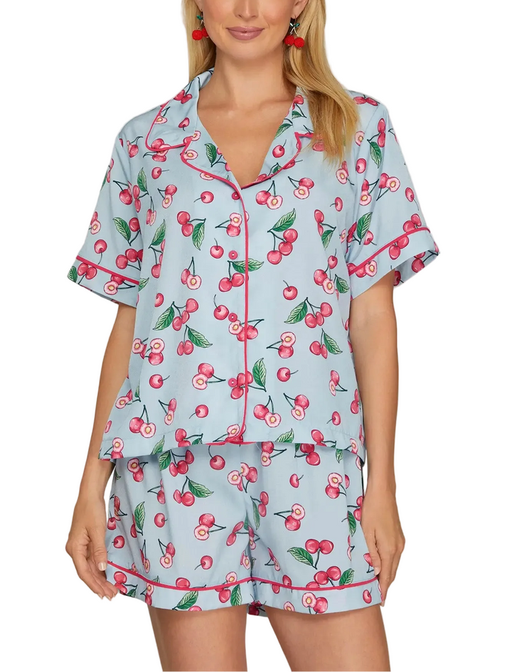 Cozy up in this charming cherry print short pajama set, perfect for warm nights and relaxed mornings. Featuring a playful cherry pattern on soft, breathable fabric, this two-piece set includes a short-sleeve top and matching shorts for effortless comfort. Ideal for lounging at home or sleeping soundly through the season. Simple, stylish, and oh-so-comfortable.
