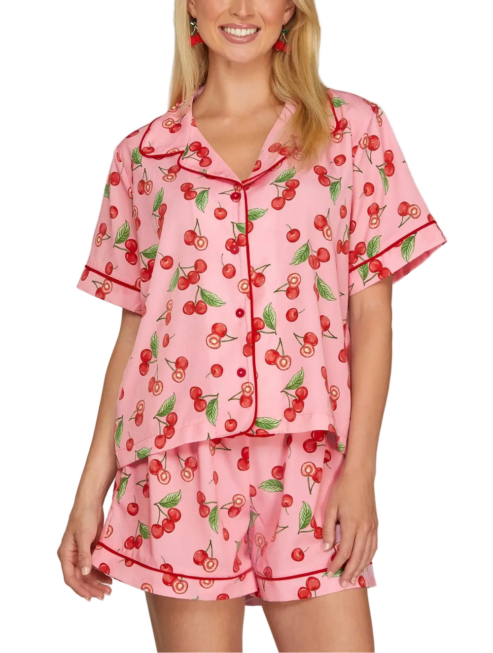Cozy up in this charming cherry print short pajama set, perfect for warm nights and relaxed mornings. Featuring a playful cherry pattern on soft, breathable fabric, this two-piece set includes a short-sleeve top and matching shorts for effortless comfort. Ideal for lounging at home or sleeping soundly through the season. Simple, stylish, and oh-so-comfortable.