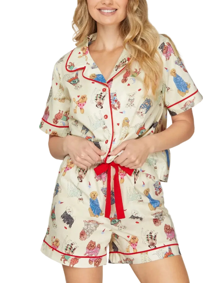 Woman wearing a patterned pajama set with a belt on a gray background
