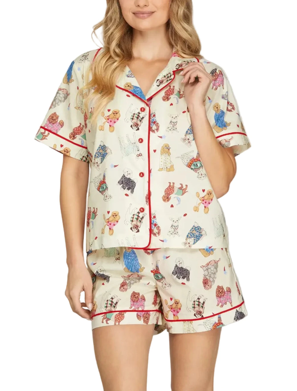 Woman wearing a patterned pajama set with cartoon characters on a plain background