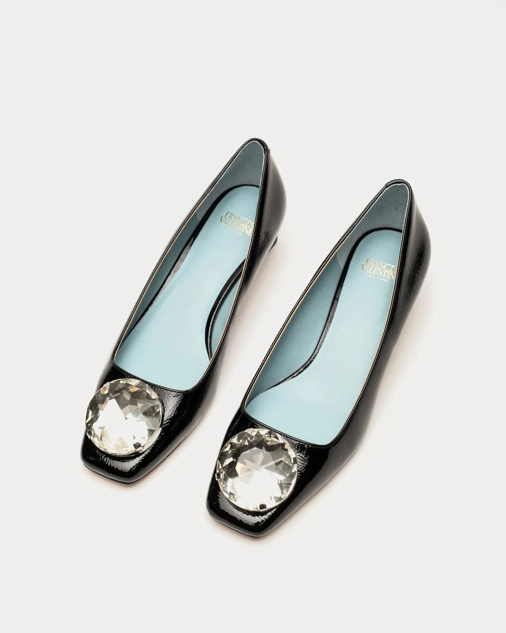 A little mod, a lot of glamour. Part of our Mod Collection, a curated lineup celebrating all things circular, the Mary block heel brings '60s polish to today’s wardrobe. Designed with a structured square toe and crafted in glossy crinkle patent leather, it’s topped with an oversized crystal ornament that steals the show. Finished with a cushioned footbed, this slip-on flat delivers equal parts comfort and charisma. A true statement shoe with vintage soul.