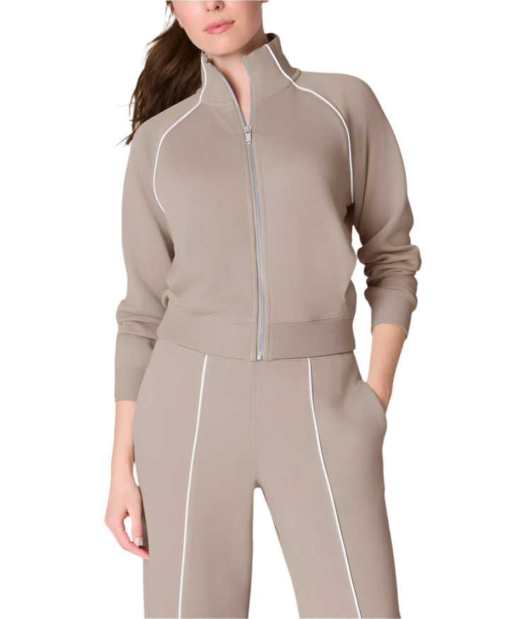 Our SPANX® AirEssentials Pique Full Zip Track Jacket is made with the same lightweight, breathable, and oh-so soft AirEssentials fabric you know and love, now with a pique application for a subtly textured look and feel. This track jacket features convenient front pockets, a full-length zipper and distinctive striped details for an easy, sporty look. Designed with 4-way stretch, it's perfect for all-day wear—whether you're traveling, running errands, or lounging at home.