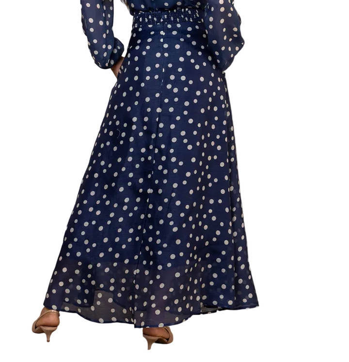Twirl into elegance with this enchanting navy organza maxi skirt, adorned with delicate polka dots that dance across the fabric. The lightweight silk organza creates an ethereal silhouette that floats with every step, perfect for adding a whimsical touch to your wardrobe. Whether you're dressing up for a special occasion or elevating your everyday style, this charming piece brings sophistication with a playful wink. The timeless polka dot pattern pairs beautifully with everything from fitted tops to flowing