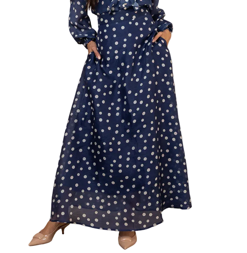 Twirl into elegance with this enchanting navy organza maxi skirt, adorned with delicate polka dots that dance across the fabric. The lightweight silk organza creates an ethereal silhouette that floats with every step, perfect for adding a whimsical touch to your wardrobe. Whether you're dressing up for a special occasion or elevating your everyday style, this charming piece brings sophistication with a playful wink. The timeless polka dot pattern pairs beautifully with everything from fitted tops to flowing