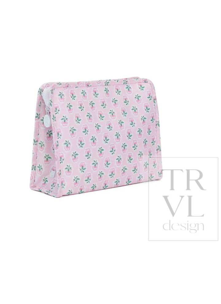 Pink cosmetic bag with floral pattern on a white background, featuring the TRVL design logo.