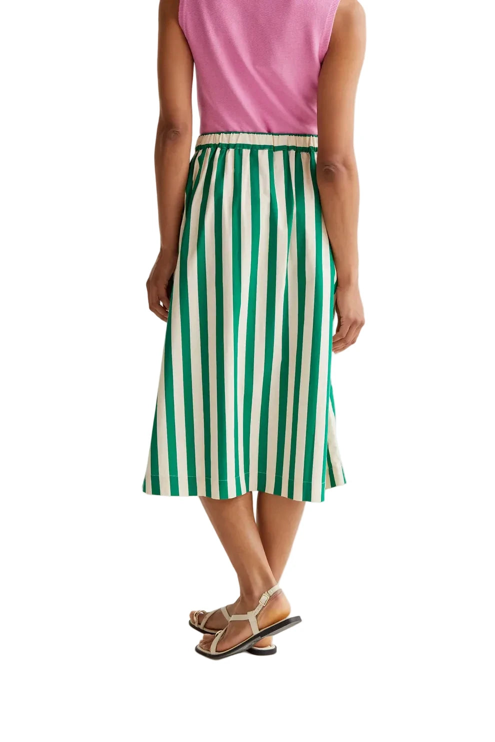 Person wearing a green and white striped skirt on a white background