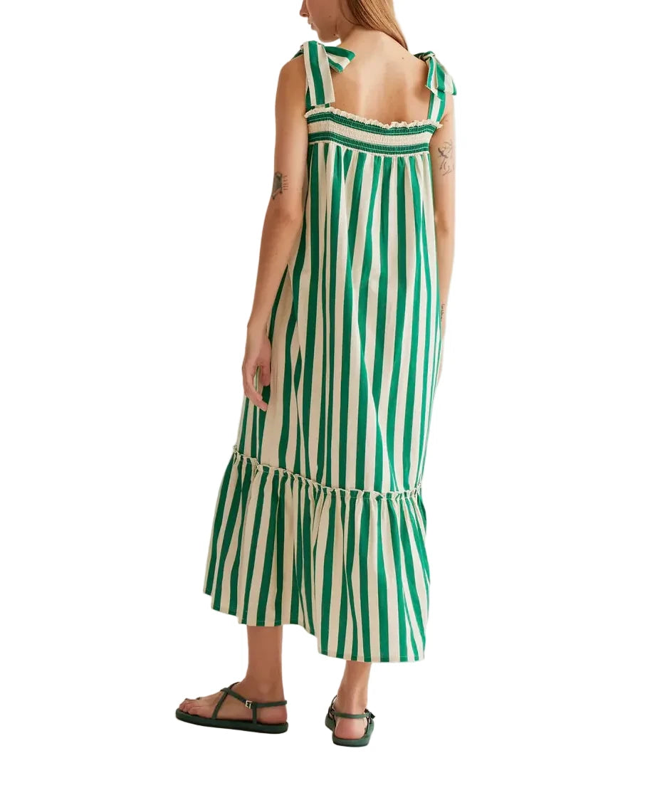 Woman wearing a green and white striped dress on a white background