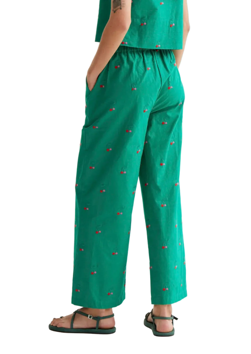 Green trousers made from 100% cotton with a green cherry print. High-waisted elastic waistband and straight leg. Side pockets.