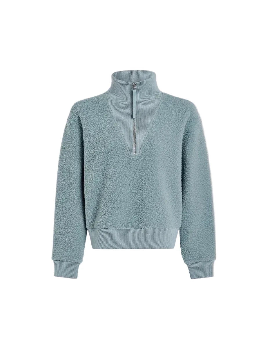 A light blue textured fleece half-zip sweatshirt with a mock neck collar, ribbed hem and cuffs, displayed on a neutral off-white background.