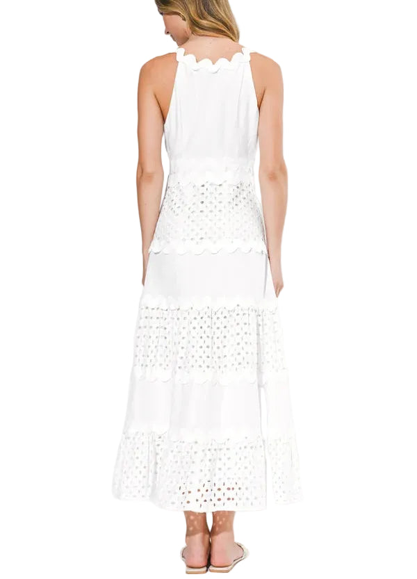 The Emma is defined by its mixed media construction, featuring a sophisticated, form-fitting bodice that seamlessly transitions into a voluminous, tiered maxi skirt. The bodice is detailed with a clean V-neckline and delicate adjustable spaghetti straps, while the skirt offers a rhythmic, ruffled texture that adds a sense of airy movement to every step.