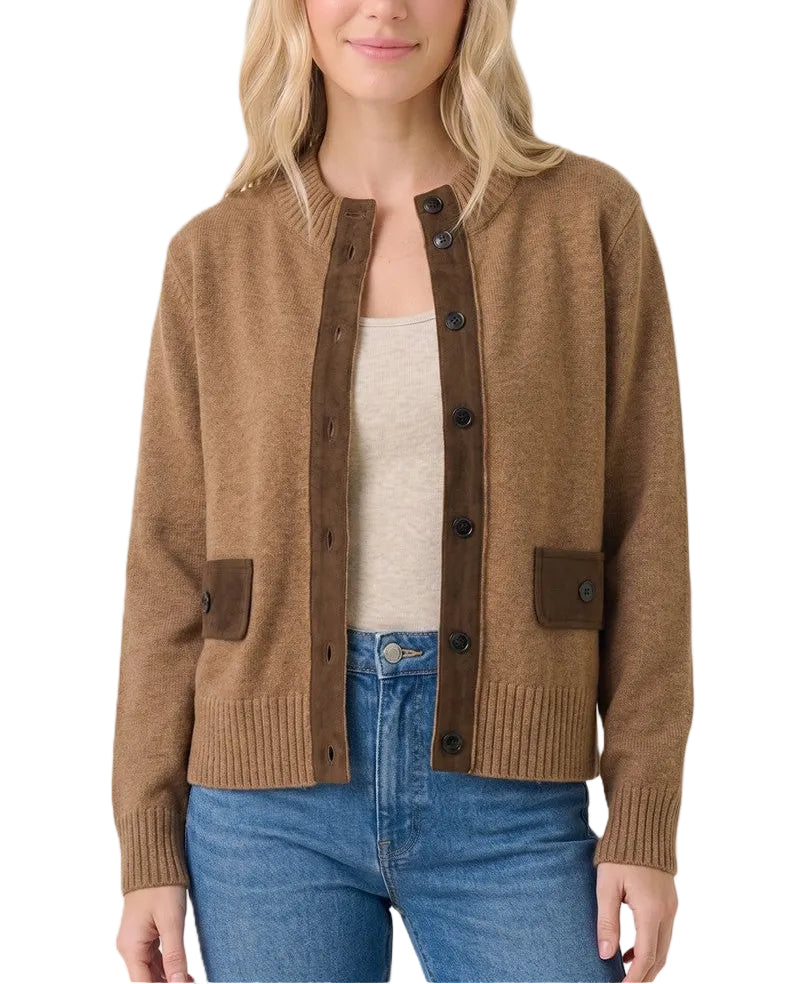 A woman modeling a brown knit cardigan with dark brown button-front placket and patch pockets over a cream tank top and blue jeans, against a light beige studio background.