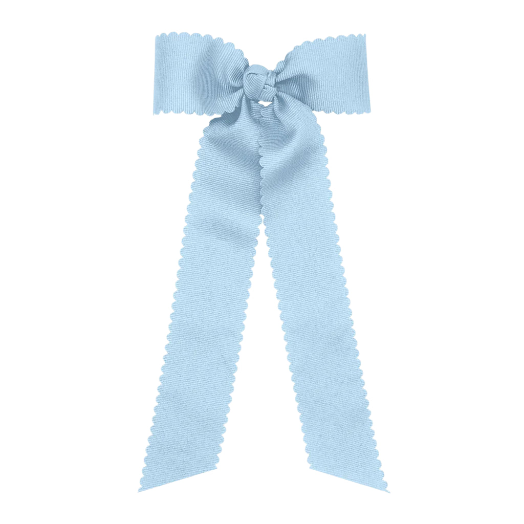 Light blue bow with long ribbons on a white background