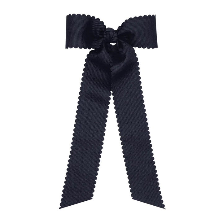 Black bow with ruffled edges on a white background