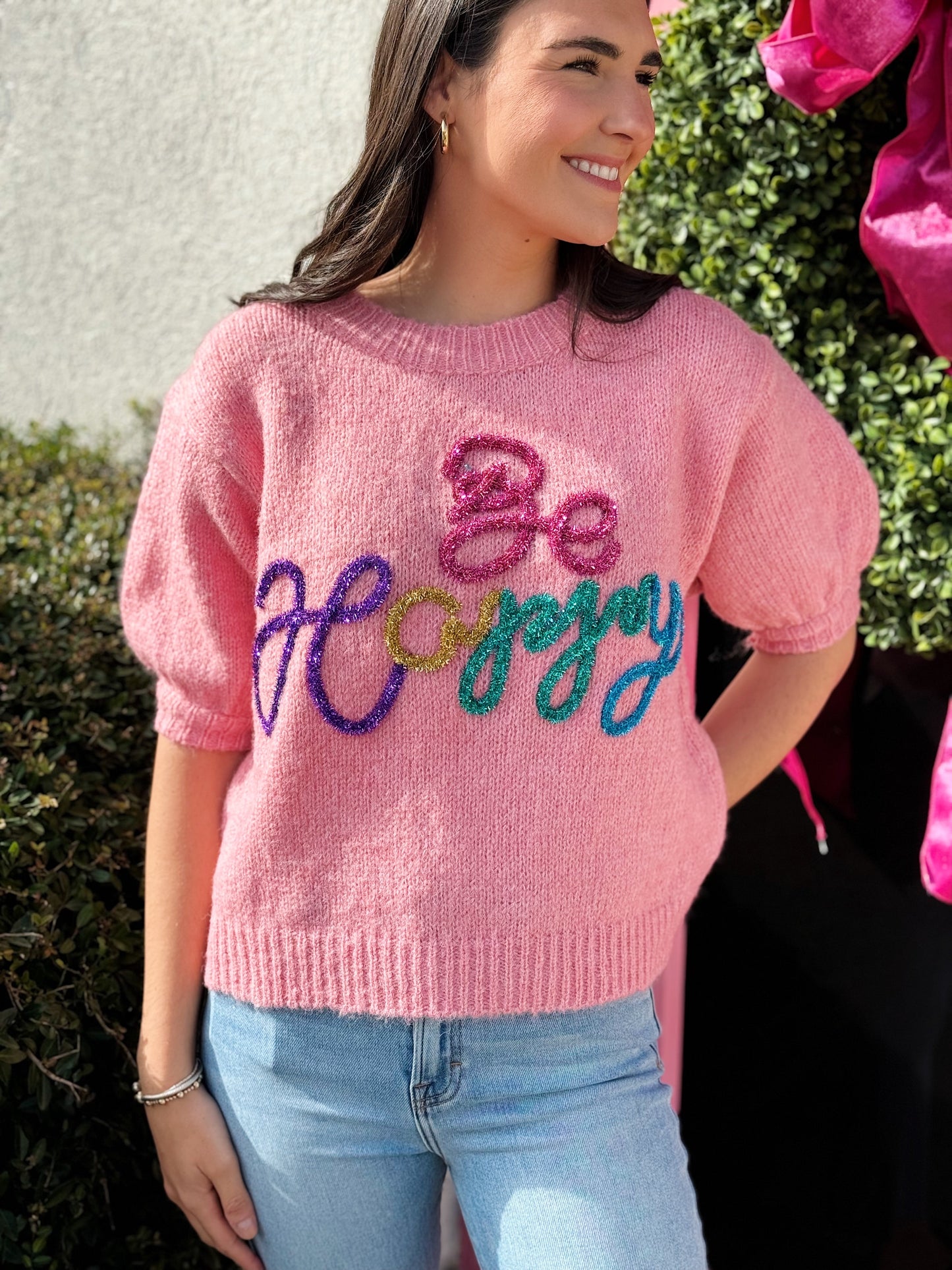 Be Happy Tinsel Short Sleeve Sweater, pink and jade sweater with “be happy” in different colored tinsel 