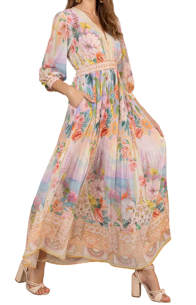 Woman wearing a colorful floral dress against a wooden wall.