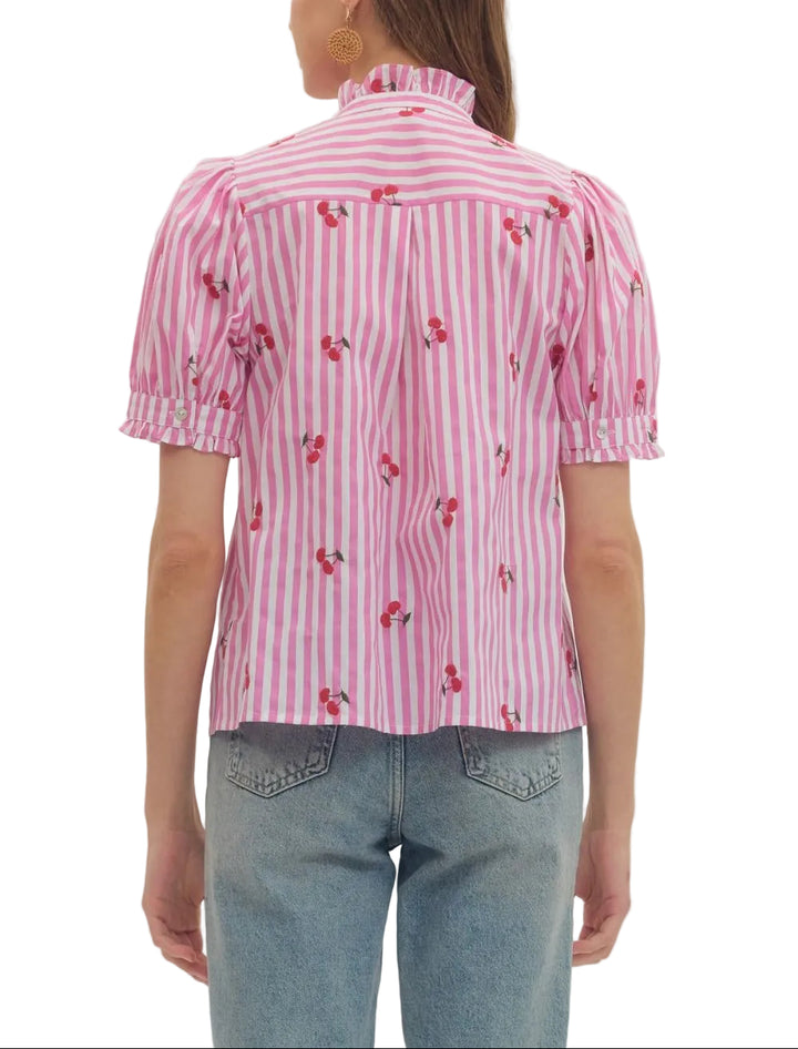 Striped embroidered cherry puff short sleeve top featuring ruffle bib front detail. Button closure at front. Ruffle trim at stand collar and sleeve cuff. Unlined. Woven. Non-sheer. Lightweight.