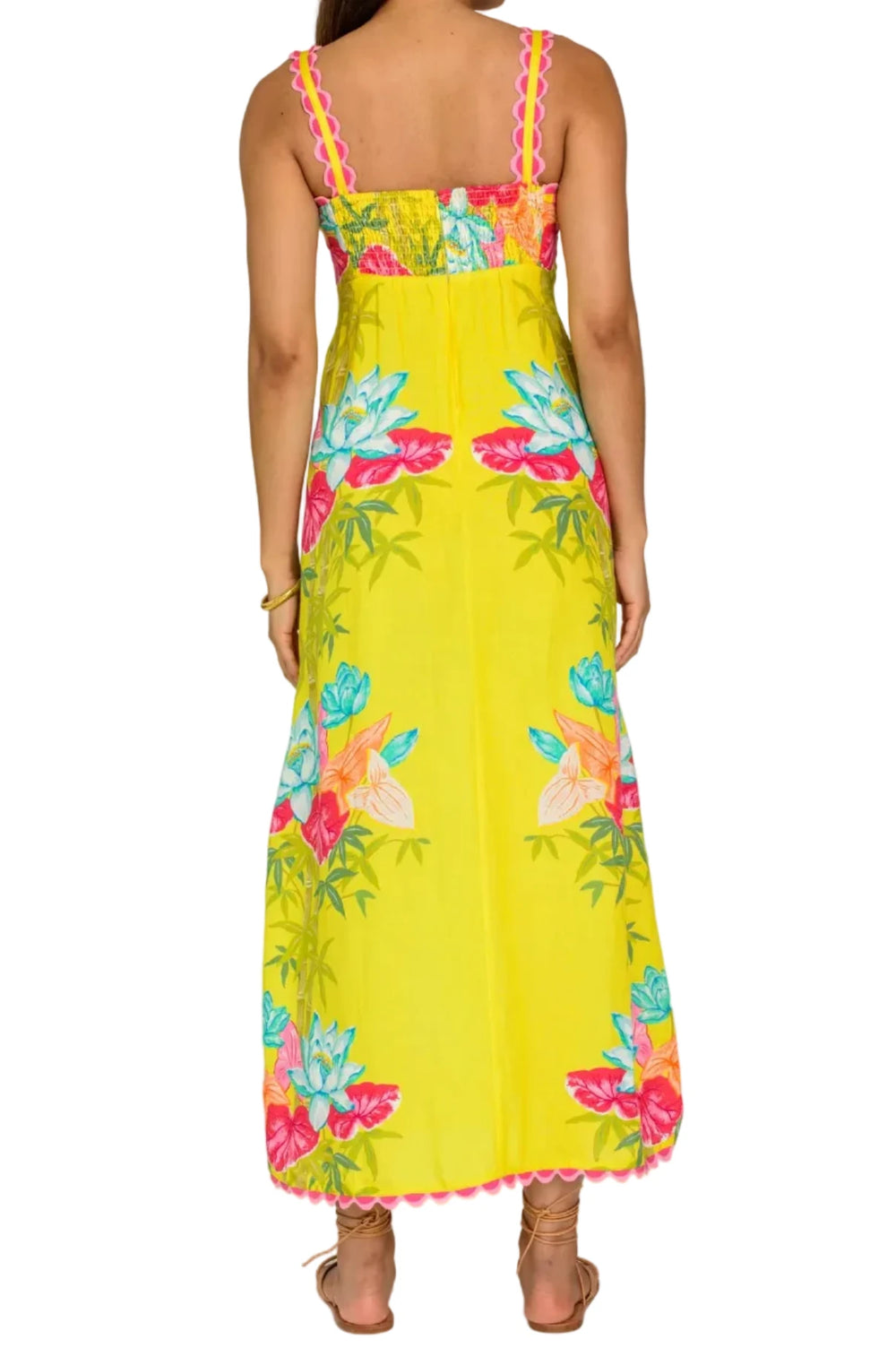 Woman wearing a yellow floral dress on a white background