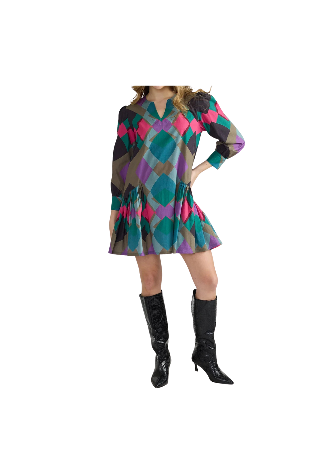 A playful split neckline and softly gathered shoulders set a breezy tone up top, while long cuffed sleeves and a relaxed body swing into a flirty drop-waist flounce at the hem. Slip on knee-high boots and let that twirl-worthy skirt do the talking.