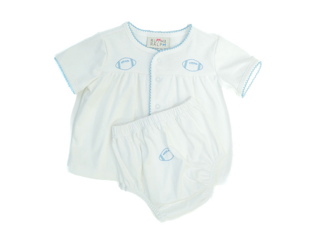 A white baby romper and matching diaper cover set by Ralph Lauren, featuring light blue trim and football-shaped embroidery on the chest and waist.