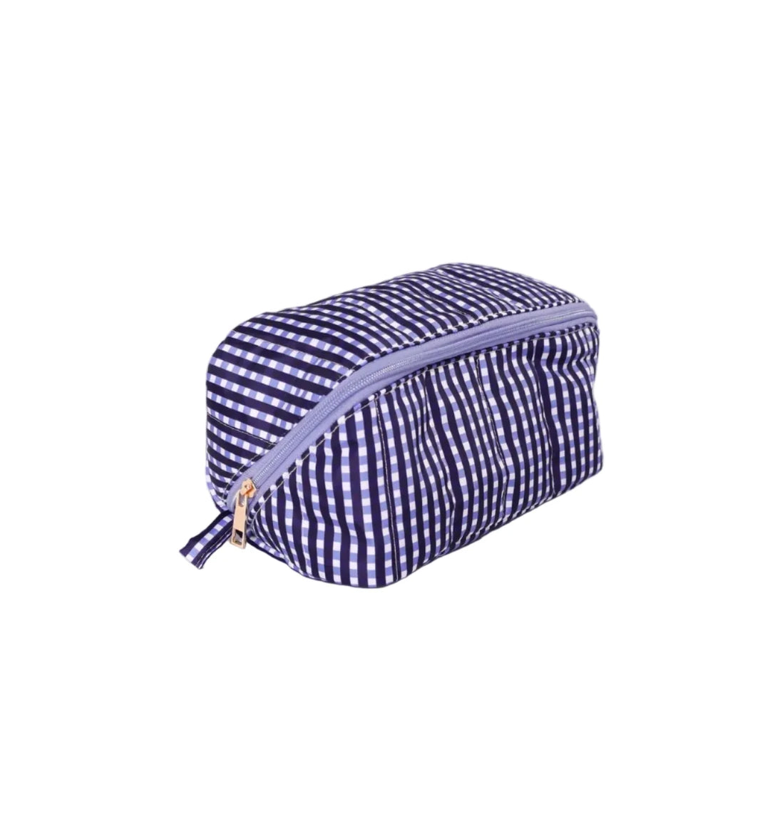 Small blue and white checkered pouch with a zipper on a light purple background