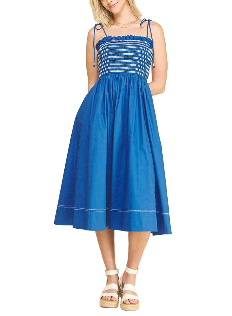 Woman wearing Blue midi dress with a smocked top with ties on the shoulder.